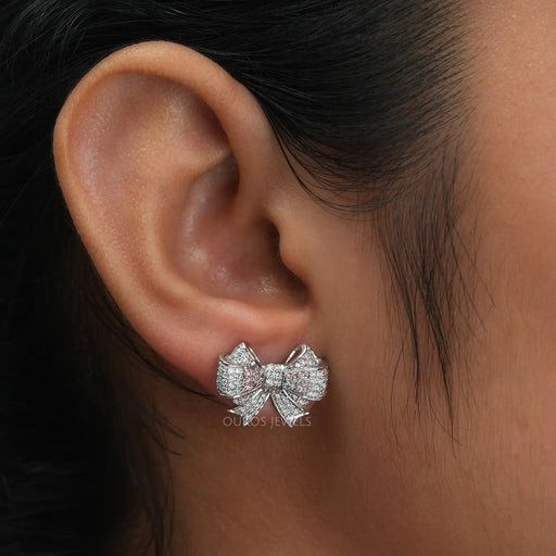 A Women wearing Bow Shaped Round Stud Diamond Earrings