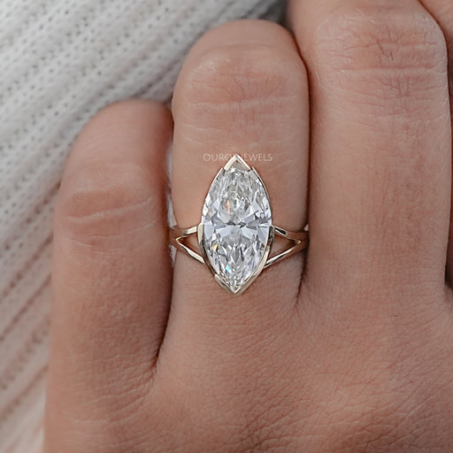 front view marquise diamond half bezel set split shank wedding ring on finger