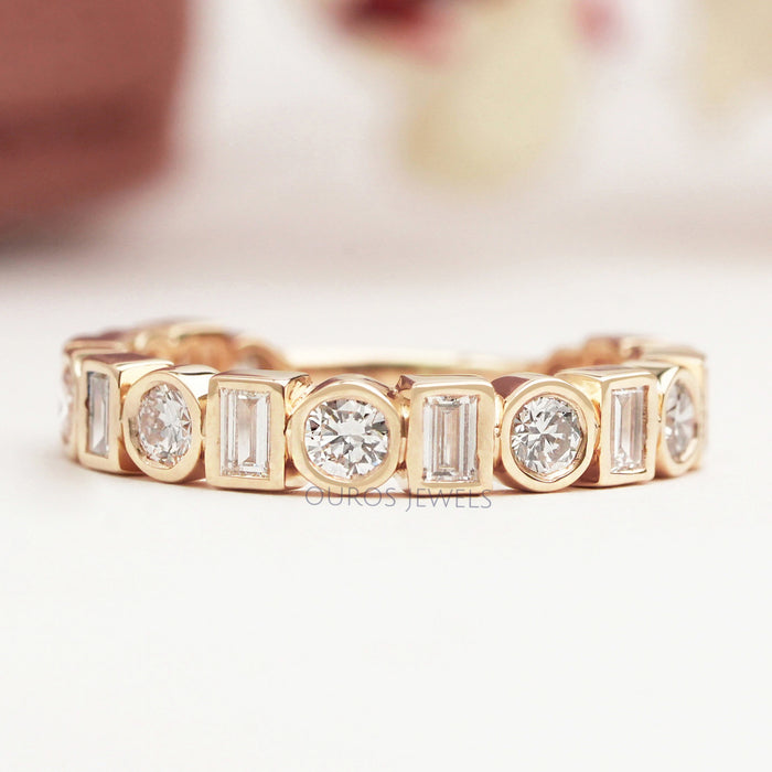 front view of baguette and round lab diamond bezel set wedding band yellow gold