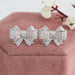 front view of pink round cut cluster diamond bow stud earrings white gold