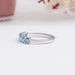 side view of blue oval-cut seven stone lab diamond wedding bands