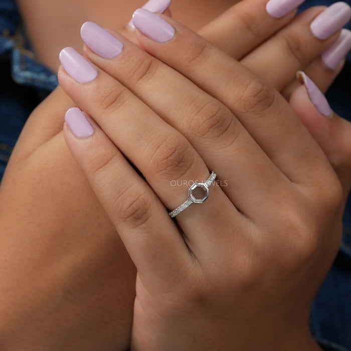 In finger front look of portrait cut octagon shape solitaire diamond engagement ring with round accent stones