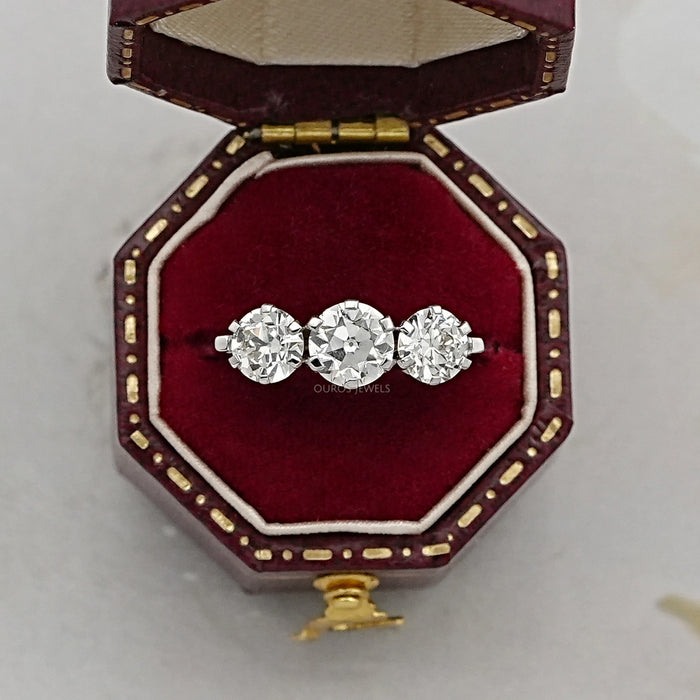 old european round cut lab diamond three stone engagement ring in jewelry box