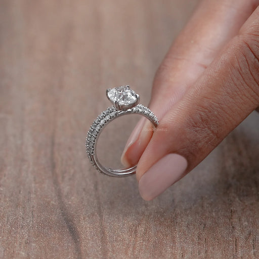 side view of old mine cushion-cut lab diamond bridal ring set on brown background