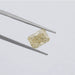 2.15 Carat Fancy Intense Yellow Radiant Cut Lab Diamond hold by tweezers against a plain grey background.