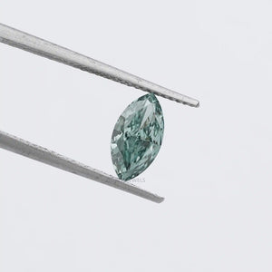 1.23 Carat Green Marquise Cut Loose Diamond held by silver tweezers against a white background, showcasing its green hue and elongated marquise shape.