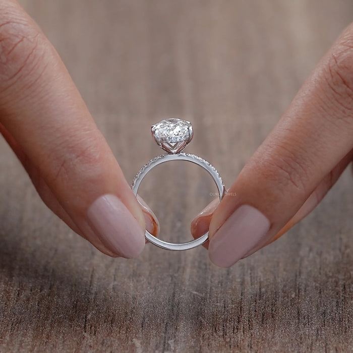 close view of oval-cut lab-grown diamond solitaire accent engagement ring