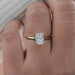 top view of oval lab diamond solitaire button back engagement ring in finger
