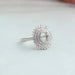 side view of oval-cut semi-mount cluster diamond engagement ring on fabric