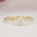 front view of pear-cut diamond solitaire accent wedding ring with yellow gold band