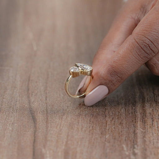 side view of two stone pear shaped diamond bezel set engagement ring