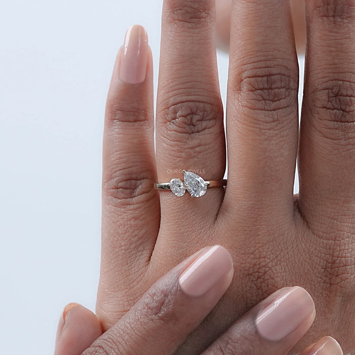 oval-cut and pear-cut lab-grown diamond toi et moi engagement ring in finger