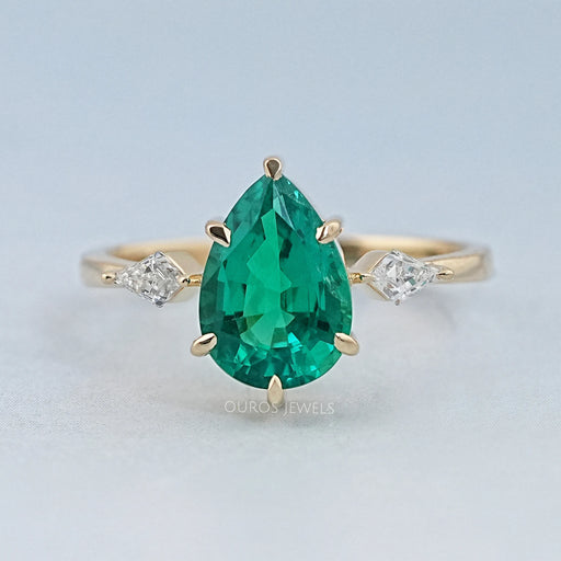 front view of green pear gemstone and kite cut diamond three stone engagement ring