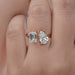 front view of emerald-cut and pear lab diamond toi et moi engagement ring