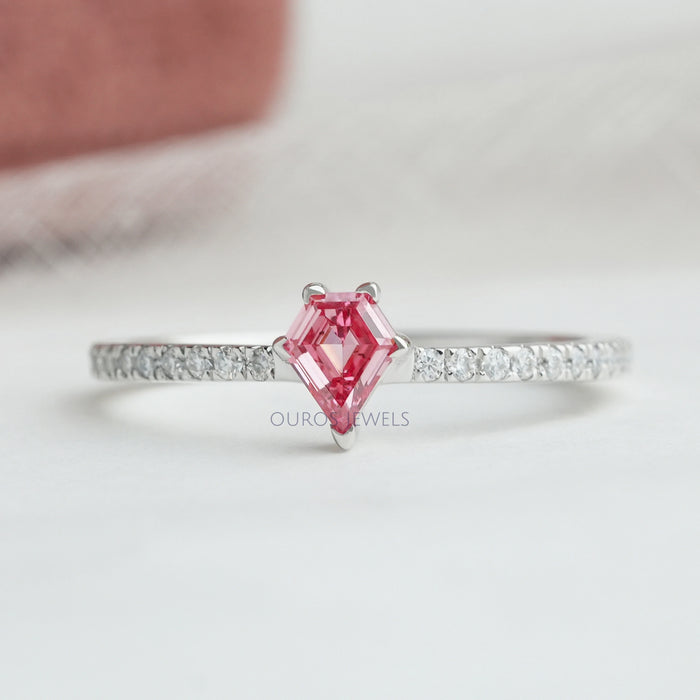 front view of pink kite-cut lab diamond solitaire accent ring on grey fabric