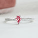 front view of pink kite-cut lab diamond solitaire accent ring on grey fabric
