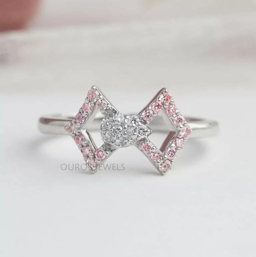 front view of round-cut lab-grown diamond classic wear bow ring pink on fabric