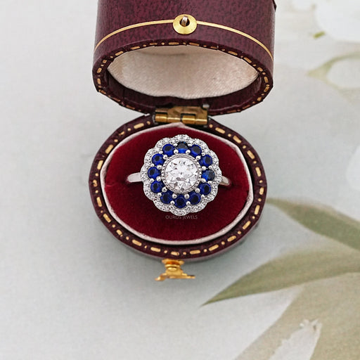 old european round cut diamond sapphire halo engagement ring in jewelry box