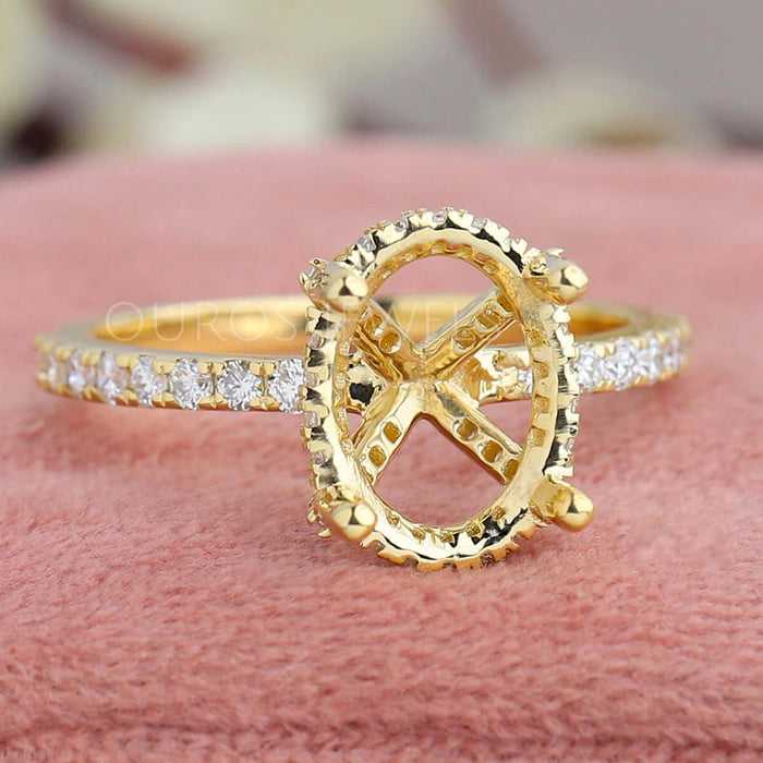 front view of solitaire accent oval-shaped semi-mount engagement ring on jewelry box