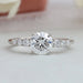 front view of 7 stone round-cut diamond solitaire accent engagement ring on fabric