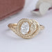 front view of snake-shaped oval-cut diamond anniversary ring with yellow gold band