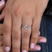 dutch marquise cut and solitaire accent diamond engagement ring in finger