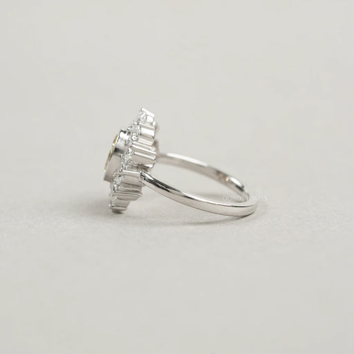 side view of yellow oval cut diamond bezel set with pear halo engagement ring