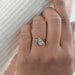 two stone pear shaped lab diamond bezel set engagement ring in finger