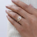 snake-shaped oval-cut diamond anniversary ring with yellow gold band on model's finger