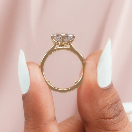 close up view of pink butterfly shape diamond solitaire proposal ring