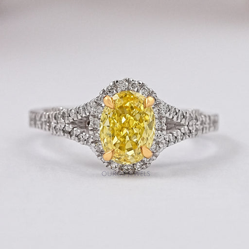 front view of yellow oval cut diamond split shank halo engagement ring