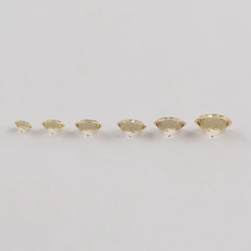 side view of brilliant round yellow lab grown diamonds loose