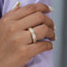 A Women wearing Bezel Set Emerald Cut Full Eternity Wedding Band in a yellow gold setting.