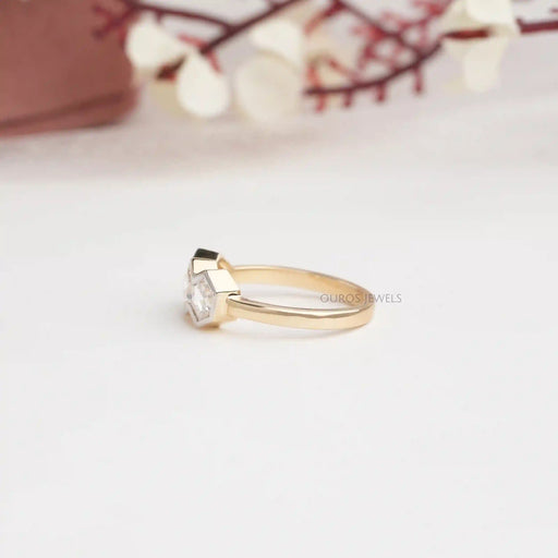 side view of three stone hexagon cut diamond bezel set engagement ring
