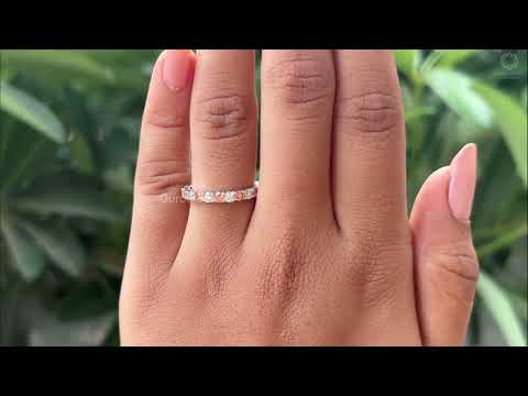 Round Cut Lab Diamond Eternity Wedding Band displayed on a finger with natural green background, As showing on youtube video.