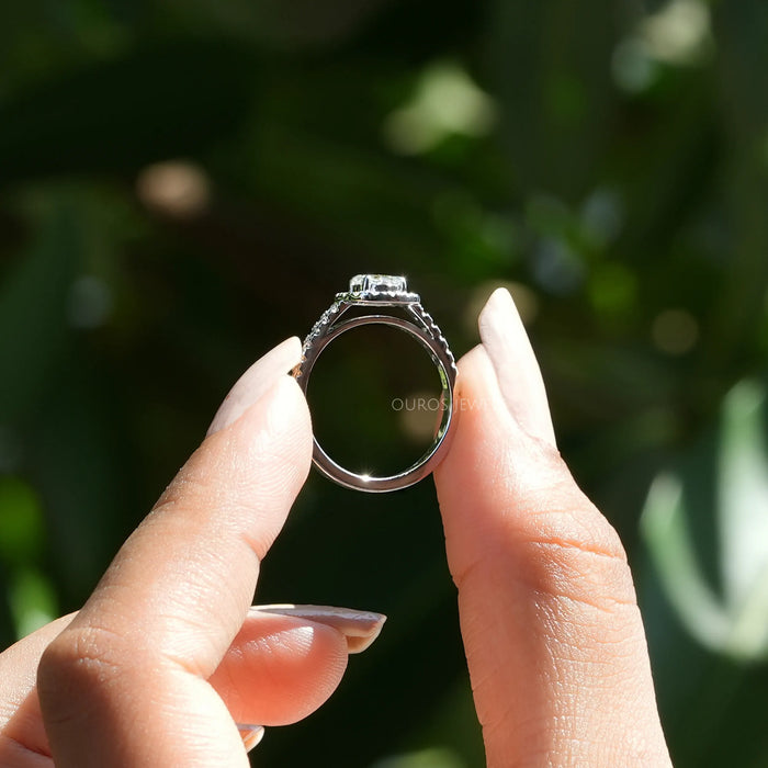 [ a  women holding a round halo lab diamond ring]-[Ouros Jewels]