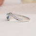 Side view of diamond heart shaped ring with curved band, this engagement ring set in bypass & side accents diamonds.