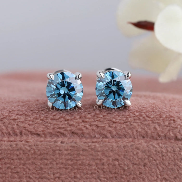 These stunning Blue Round Diamond Solitaire Stud Earrings are elegantly crafted to add a touch of glamour to any outfit