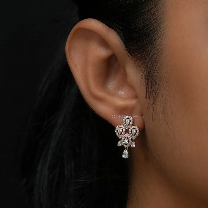 Flower shaped diamond earrings with a cluster of pear cut lab diamonds