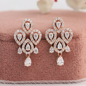 A stunning pair of eco friendly diamond earrings made with pear shape diamonds with halo of round diamonds