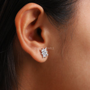 Marquise Cut Cluster Stud Earrings shown worn on an ear, highlighting the elegant floral design and the sparkling lab-grown diamonds against the skin.