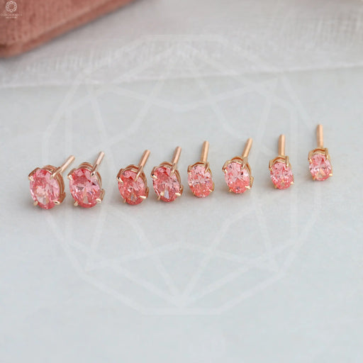 side view of pink oval cut man made diamond studs earrings rose gold