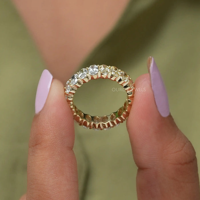 A close look lustrous yellow gold diamond band with oval cut VS clarity diamonds
