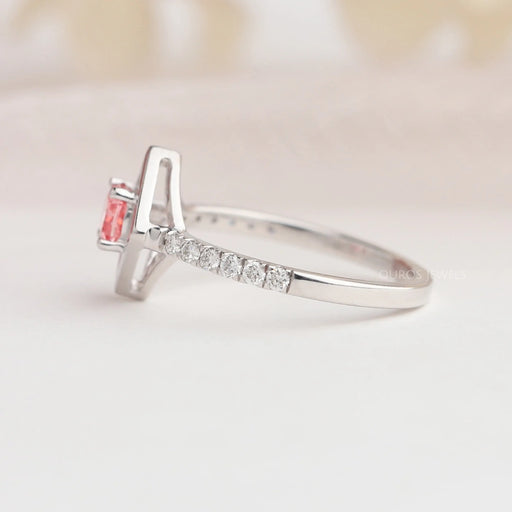 Side view of 14k white gold cushion cut solitaire engagement ring set in side accents diamonds.