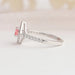 Side view of 14k white gold cushion cut solitaire engagement ring set in side accents diamonds.