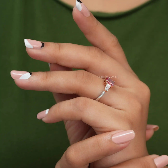 In finger side look of pink radiant 3 stone diamond engagement ring
