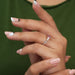 In finger side look of pink radiant 3 stone diamond engagement ring