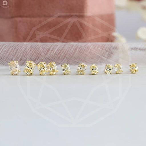 top view of yellow oval cut man made diamond screw back earrings gold