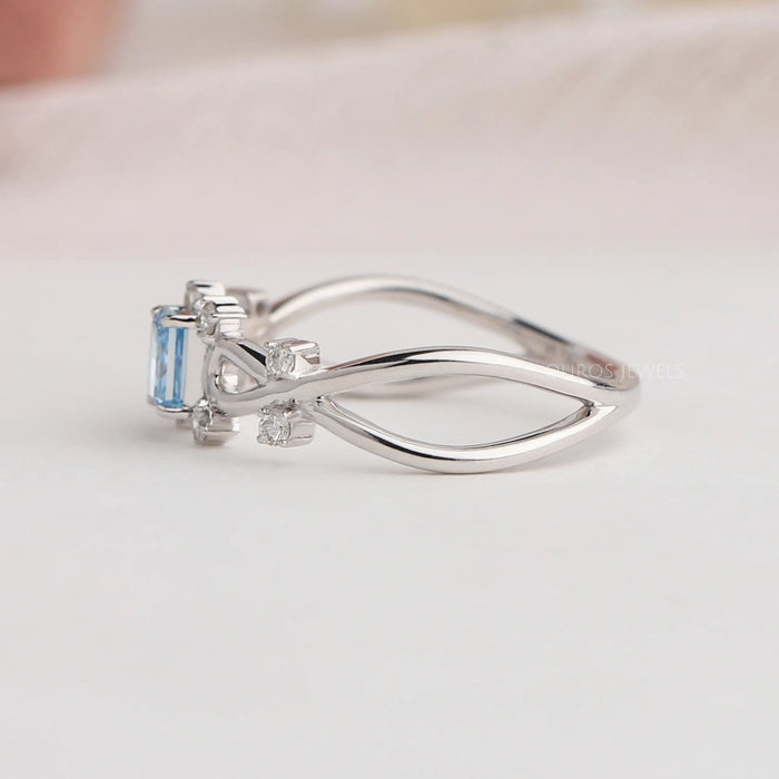 14k white gold infinity shaped curved shank of blue radiant diamond ring