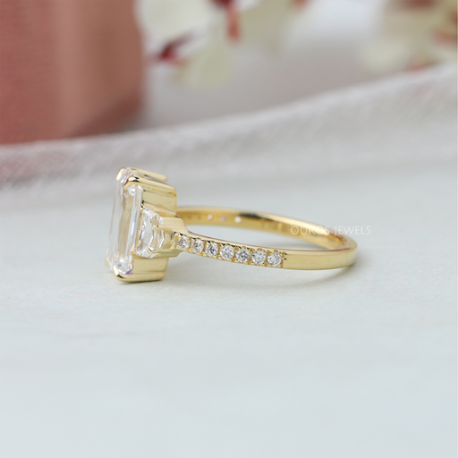back view of criss cut diamond three stone engagement ring with yellow gold band